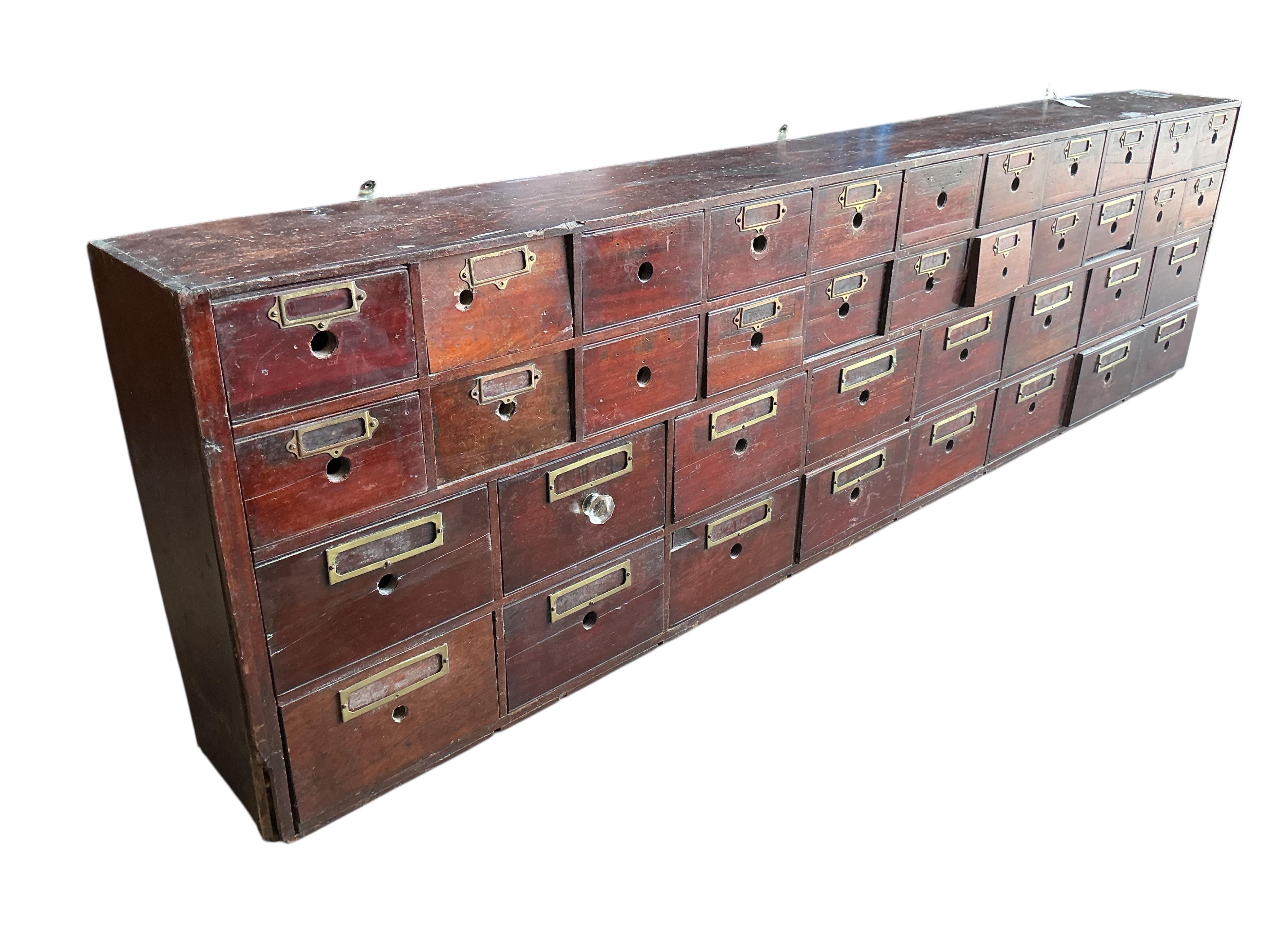 A Victorian pine and mahogany bank of apothecary drawers, width 217cm, depth 23cm, height 60cm